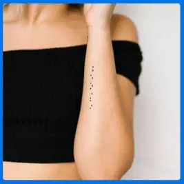 code tattoo in woman arm