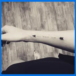 arrow tattoo in female arm